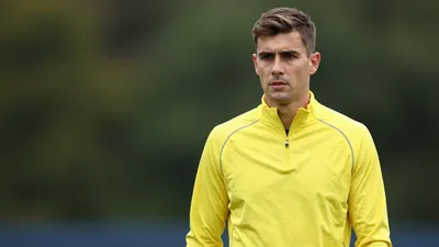 Mid-30s athletic midfielder, lean build, waist-up, face sharp and expressive, wearing a plain unmarked Cape Town City FC...