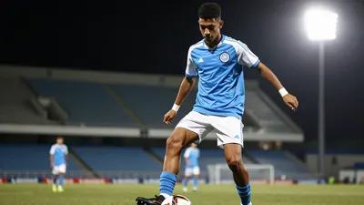 A photorealistic image of a 17-year-old, Cape Town City FC U-17 player, wearing a blue jersey with white sleeves, and...