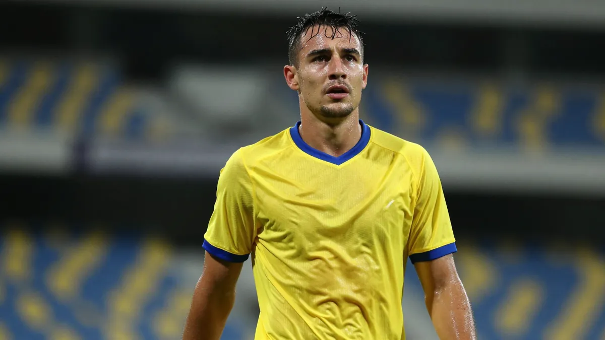 Mid-30s Cape Town City FC midfielder, athletic build, waist-up, drenched in sweat, eyes focused, wearing a plain yellow...