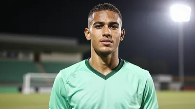 A young Cape Town City FC player, 20-25 years old, with a lean build, wearing the new mint-green away kit, made of...